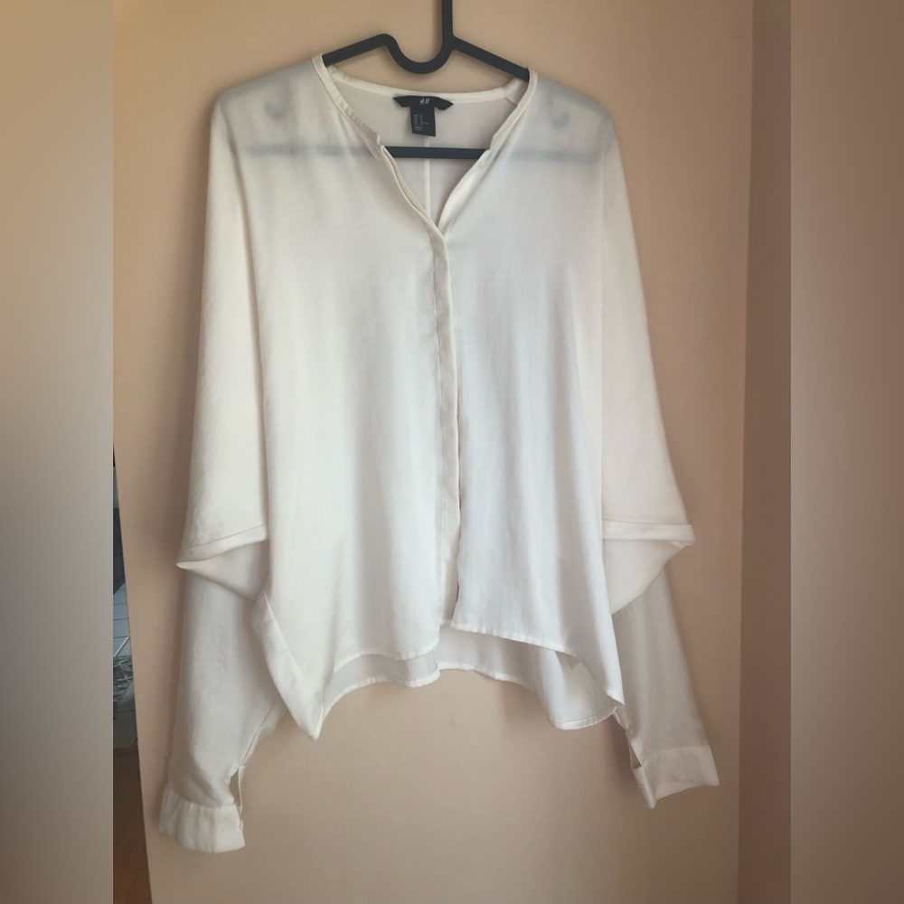 Classy ivory color button down blouse with wide sleeves. Never worn.